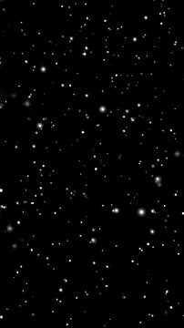 Abstract outer space animation with glistening white stars against a dark background, representing cosmic travel and sci fi concepts Vertical video