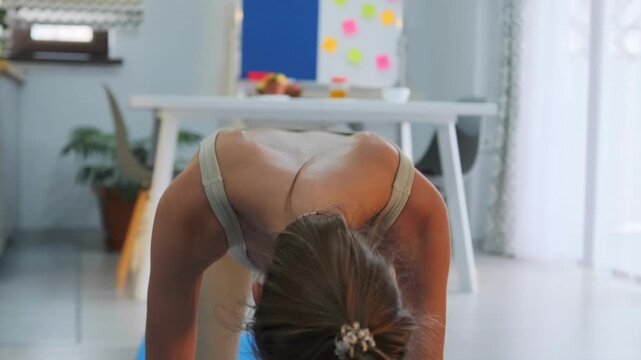 Women on mats performing child pose and downward facing dog yoga sequence indoors. Home yoga workout for flexibility -  balance and wellness lifestyle.