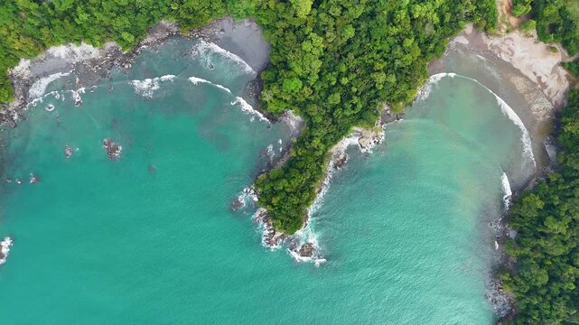 High altitude top down drone view showing Playa La Macha and surrounding beaches near Quepos, Costa Rica.