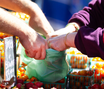 Purchasing vegetables at an outdoor flea market.