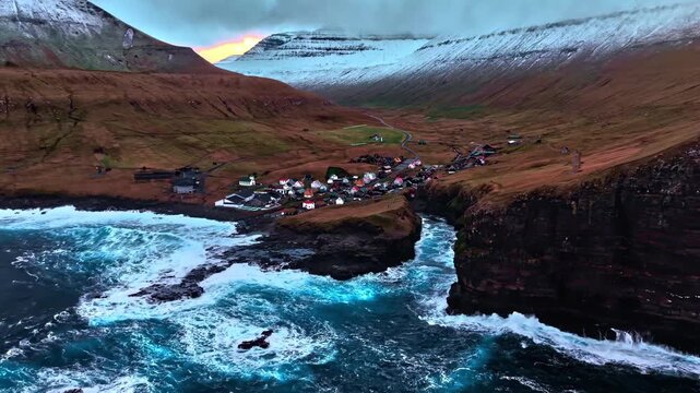 Aerial view of coastal vilage Gjogv with natural gore and rough sea