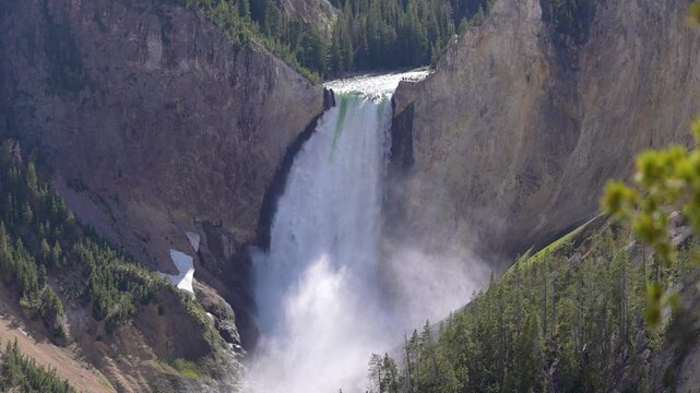 Close-up shot of the Lower Falls in Yellowstone National Park, Wyoming, highlighting the powerful flow of water and the rugged canyon walls