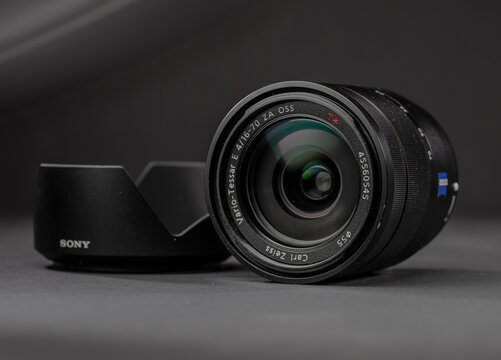 Gothenburg, Sweden - december 09 2023: Professional Sony Zeiss zoom lens with lens hood displayed in studio lighting.