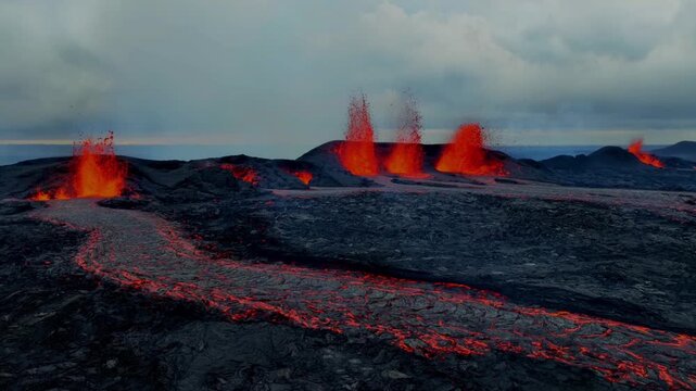Aerial view of active volcno eruption with flowing lva rivers and craters