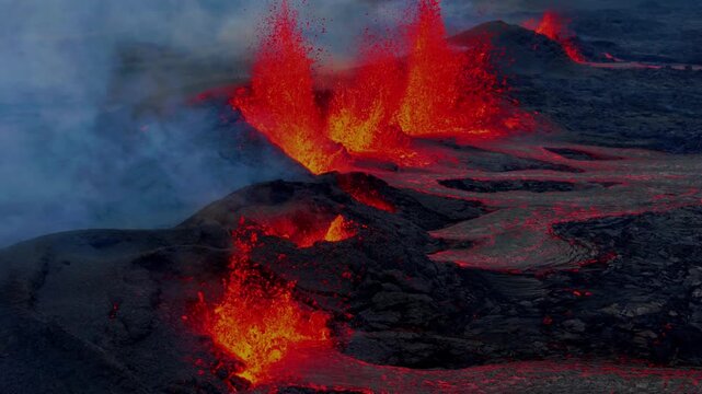 Close-up aerial view of acive volcano eruption with ava fountains
