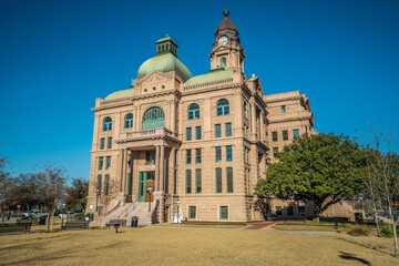 Front Entrance of Courthouse Building With Tall Clock Tower in Historic City of Fort Worth Texas With Front Courtyard and Blue Sky