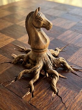 A chess knight with organic roots digging into the board, a powerful metaphor for strategic stability, entrenched positions, and long-term growth.