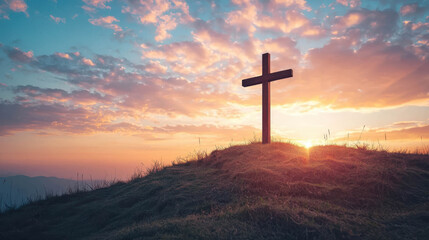 Wooden cross on a hill at sunrise against a colorful sky, conveying easter faith, hope, resurrection and spiritual reflection
