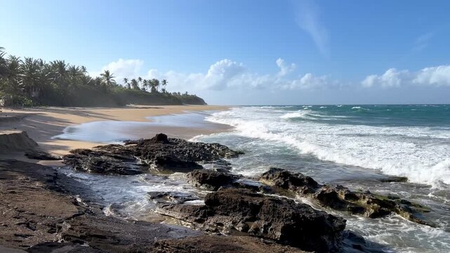 Waves crash on a rocky shoreline in puerto rico under a blue sky