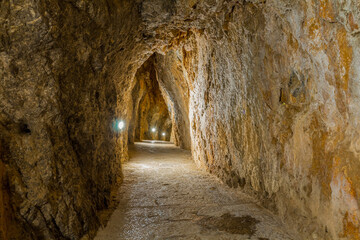 A path carved into the rock leading to Torrent de Pareis in Mallorca. A narrow, scenic trail surrounded by steep cliffs and rugged mountain landscape, offering spectacular views and a unique hiking ex © johnkruger1