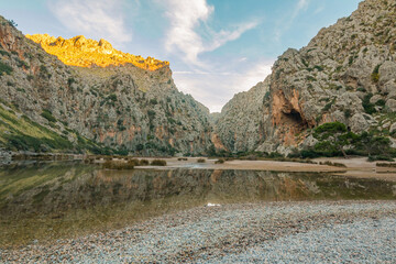 Golden sunset over Sa Calobra and Torrent de Pareis, Mallorca. Towering cliffs, crystal waters, and a magical valley create one of the island’s most unforgettable coastal masterpieces. © johnkruger1