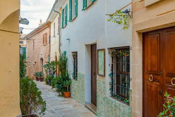 Fototapeta premium Historic town of Alcudia in Mallorca, known for its well-preserved medieval walls, charming old streets, and lively atmosphere. A popular destination offering cultural heritage, local shops, and tradi