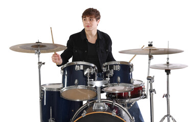 Teenage boy with drumsticks learning how to play drums on white background