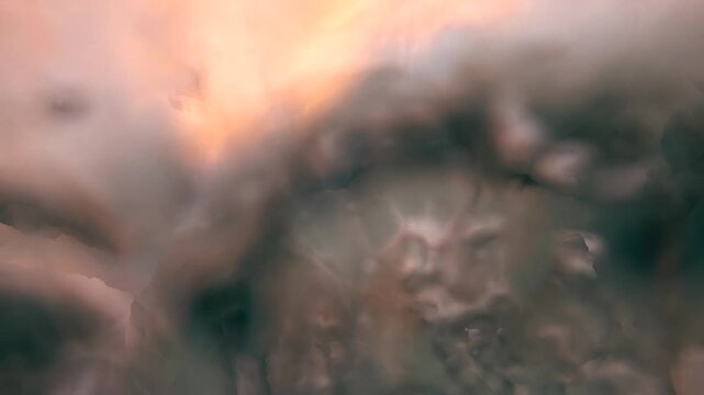 Slow motion footage of a breaking ocean wave at sunrise at Bronte Beach, Sydney, Australia, with warm light reflecting across the moving sea surface.