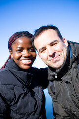 Two diverse individuals posing together.