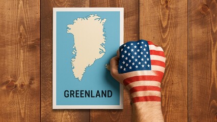 Obraz premium United states fist claiming greenland map geopolitics concept