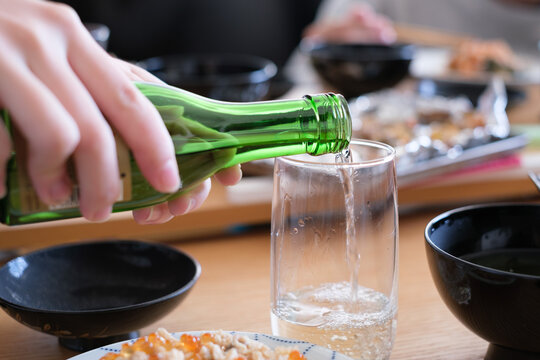 Fine sake flowing gracefully into a glass 
