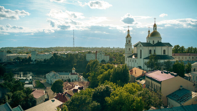 The white Holy Assumption Cathedral with golden domes stands on a hill in Vitebsk, Belarus.
