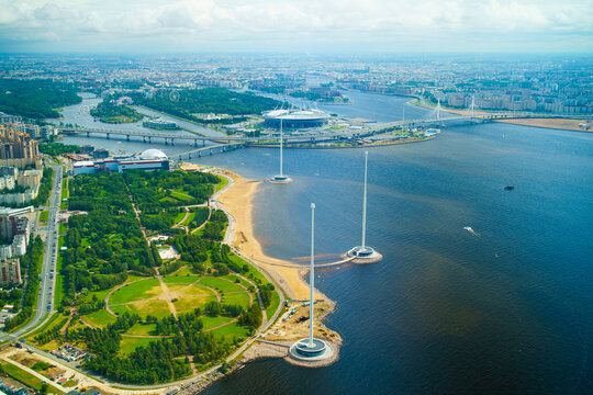 An aerial view of the Park of the 300th Anniversary of St. Petersburg and tall flagpoles on the coastline.