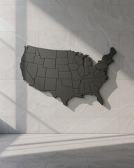 A gray map of the united states mounted on a white wall with shadows