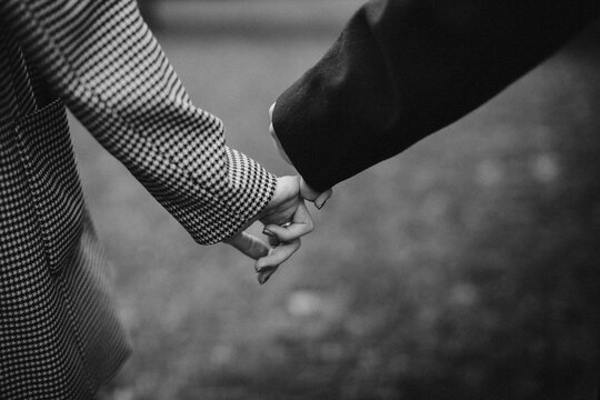 Couple holding hands joining fingers together