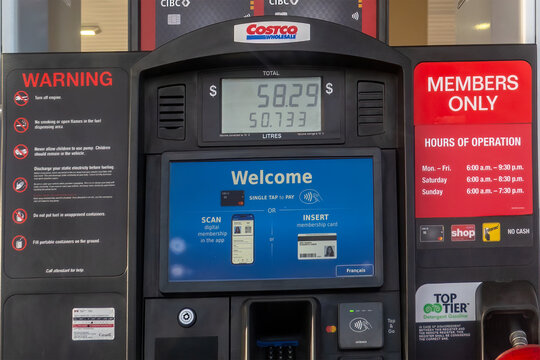 Calgary, Alberta, Canada. Feb 2, 2026. A digital display on a Costco Wholesale gasoline pump showing pricing and payment instructions.