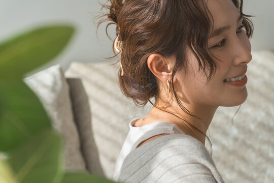 Profile of a woman wearing accessories, earrings, and earrings