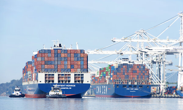 Oakland, CA - Feb 2, 2026: APL Cargo Ship President Monroe entering the port of Oakland with multiple tugboats assisting the vessel to maneuver.