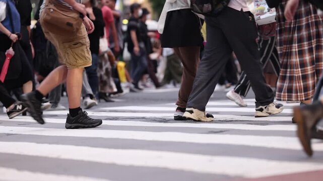Low Angle View of World's Busiest Crosswalk At Dusk Focus On Feet