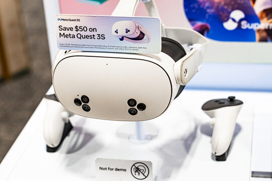 Meta Quest 3S virtual reality headset with controllers displayed on retail stand, modern VR gaming technology and immersive entertainment device