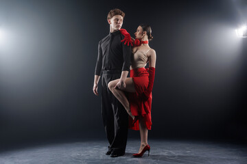 Professional ballroom dance couple practicing tango choreography in studio