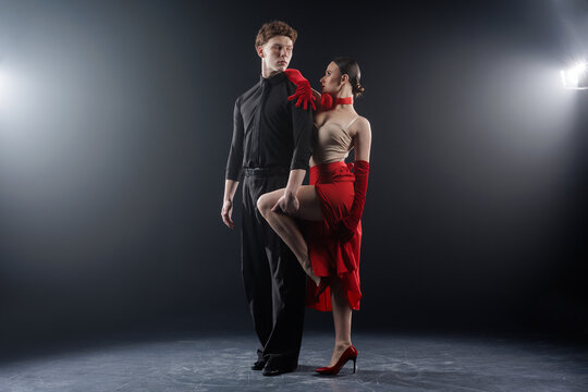 Professional ballroom dance couple practicing tango choreography in studio