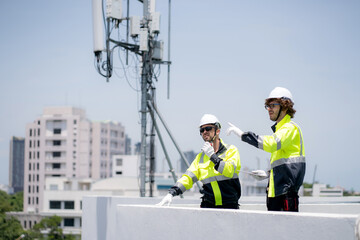 Professional telecommunication technician team talking walkie-talkie radio command rooftop cell...