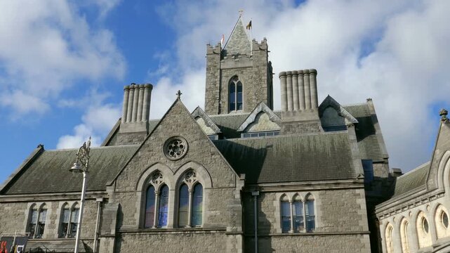 Facade tower of Synod hall, part of Christ Church Cathedral in Dublin, Republic of Ireland. Shot on a sunny day with blue skies and white clouds.