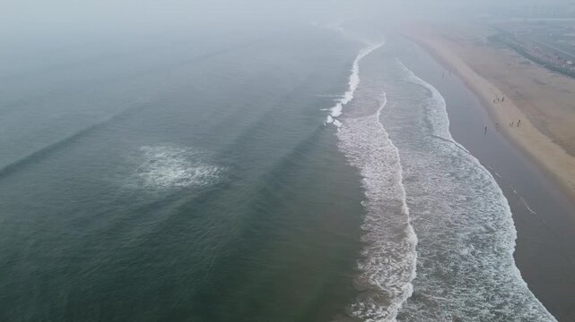 aerial top view drone video clip of scenic wave formation in a sea beach of famous travel destination city Puri in India