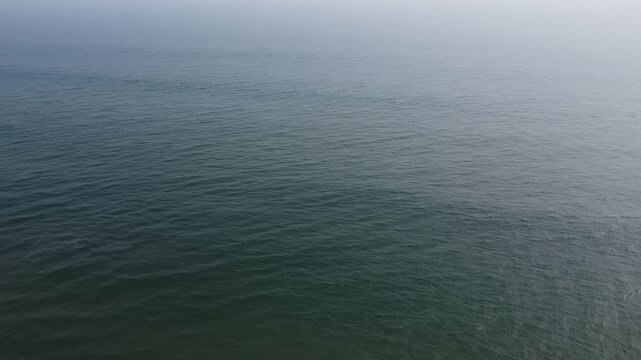 aerial top view drone video clip of scenic wave formation in a sea beach of famous travel destination city Puri in India