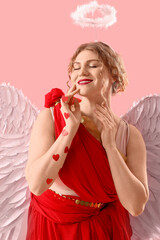 Fototapeta premium Beautiful woman dressed as Cupid on pink background. Valentine's Day celebration