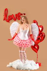 Fototapeta premium Sexy young woman dressed as Cupid with balloons on cloud against beige background. Valentine's Day celebration