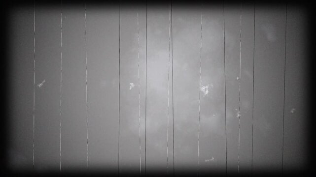 Old Film Scratches Video. Old film scratches add age and damage to a cloudy sky, creating a vintage feel. Suitable for cinematic backgrounds or creative projects.