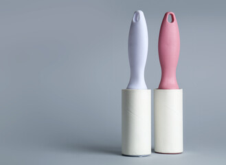 Sticky lint rollers on grey background