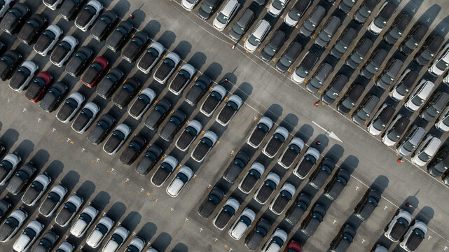 Aerial view car for sale stock lot row, Cars dealership inventory distribution automobile and automotive business, New cars parking for sale automobile automotive industry business.