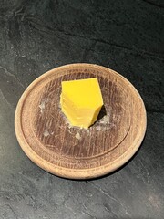 A wood plate with butter