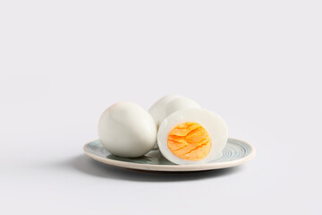 Plate with tasty boiled eggs on white background, closeup