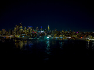 Panoramic night view of Midtown Manhattan skyline across the Hudson River, New York City