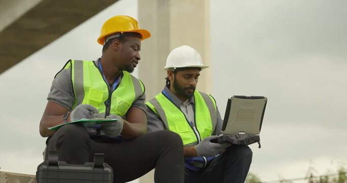 Railway engineer and technician conduct quality control material inspection on concrete pier segments and construction waste. Checking structural condition for safe site housekeeping and asset reuse.

