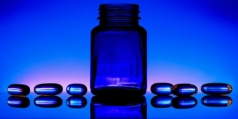 Blue glass bottle with capsules on reflective surface