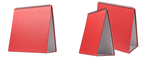 a single red spiral-bound desk calendar stands open, showcasing its minimalist design and clean white pages against a white, isolated background, ideal for planning and organization concepts. © Ladislav