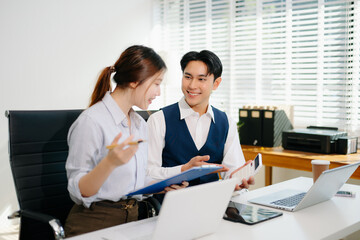 Fototapeta premium Business coworkers working together at office desk using laptop. Professional teamwork, corporate collaboration, digital strategy, productivity