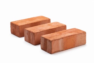 Three red clay bricks in staggered formation on white background red brick construction