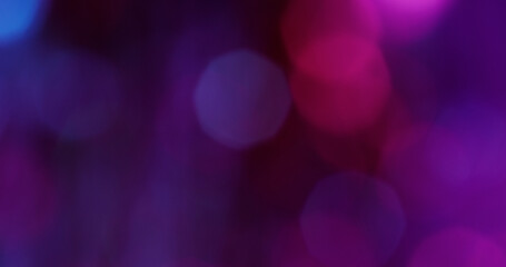 Defocused gleam light. Neon bokeh glare. Purple pink blue color glimmer round texture sparkling...